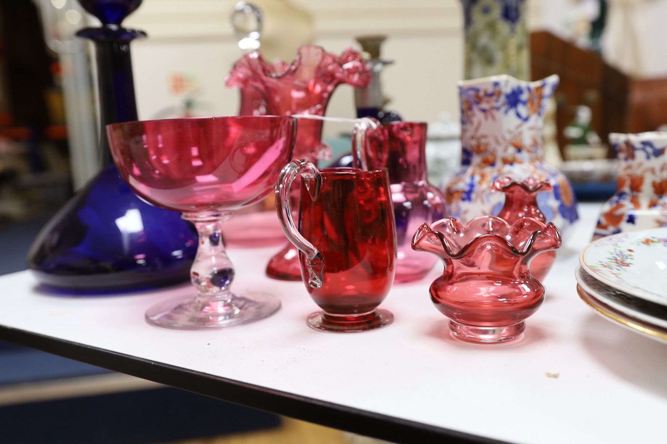 An assortment of cranberry glassware, graduated Masons Ironstone jugs, Chinese export plates etc.